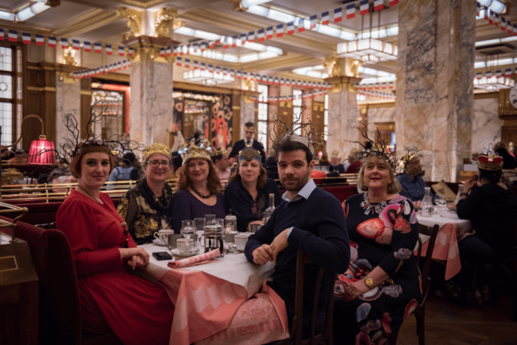Guests wearing crowns for Fete des Rois at Brasserie Zedel